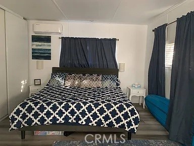 5700 Carbon Canyon Road, Unit 62 Brea, CA 92823 - Photo 2 of 4 a bed sitting in a bedroom next to a window and dresser