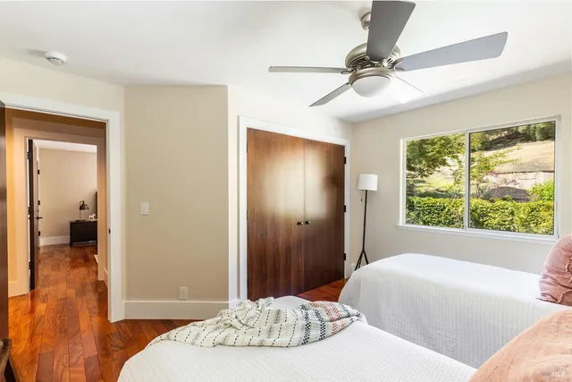 a bedroom with a bed and a large window