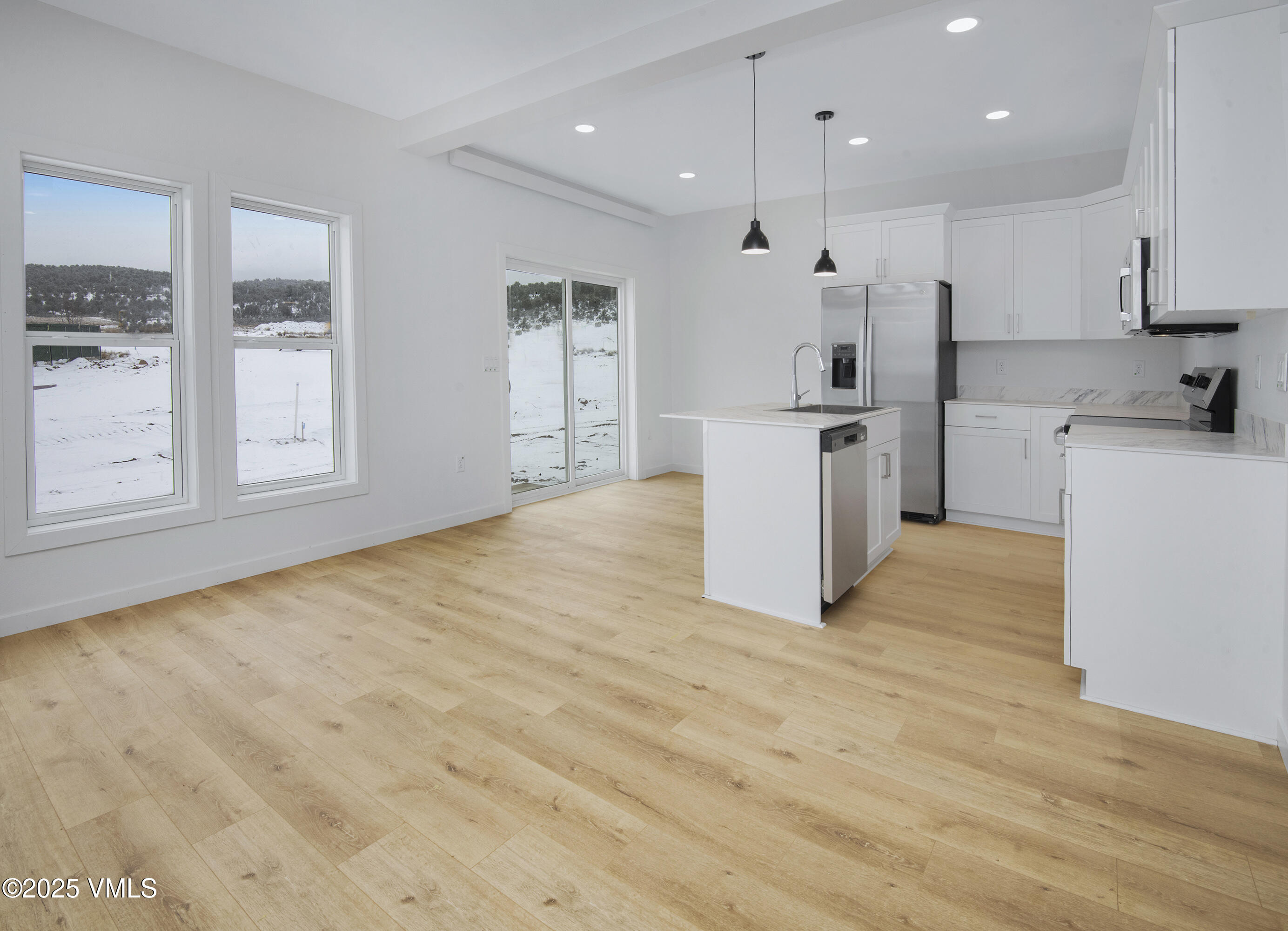 60 Comanche Way Gypsum, CO 81637 - Photo 9 of 46 a kitchen with white cabinets and white appliances
