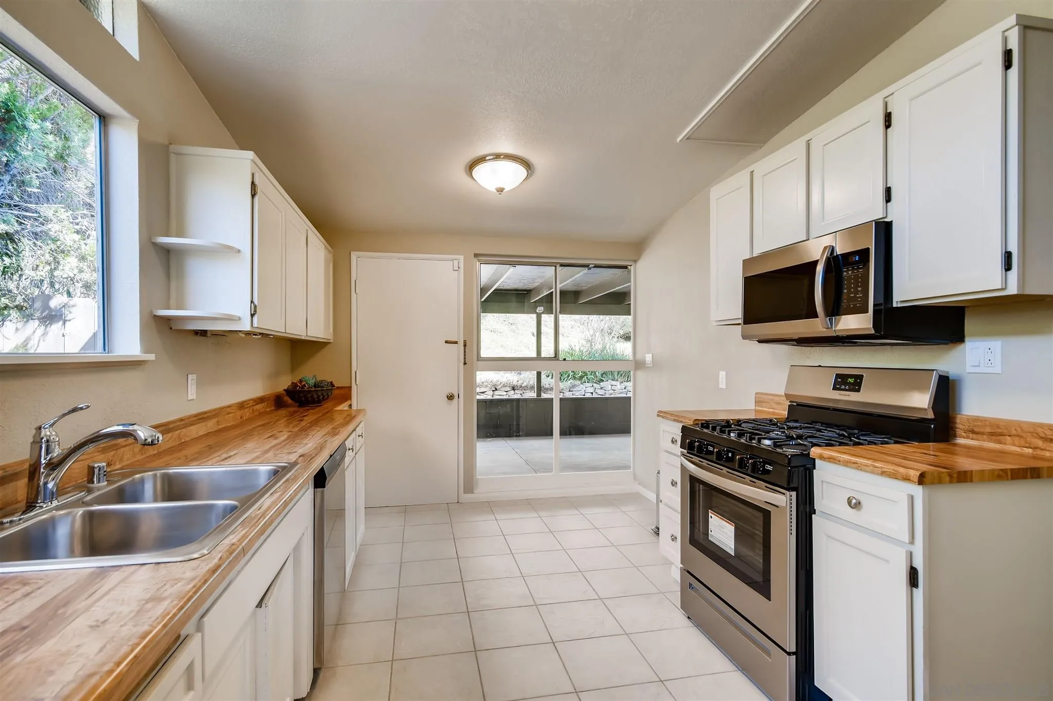 13815 Frame Road Poway, CA 92064 - Photo 4 of 12 a kitchen with granite countertop a sink a stove and cabinets