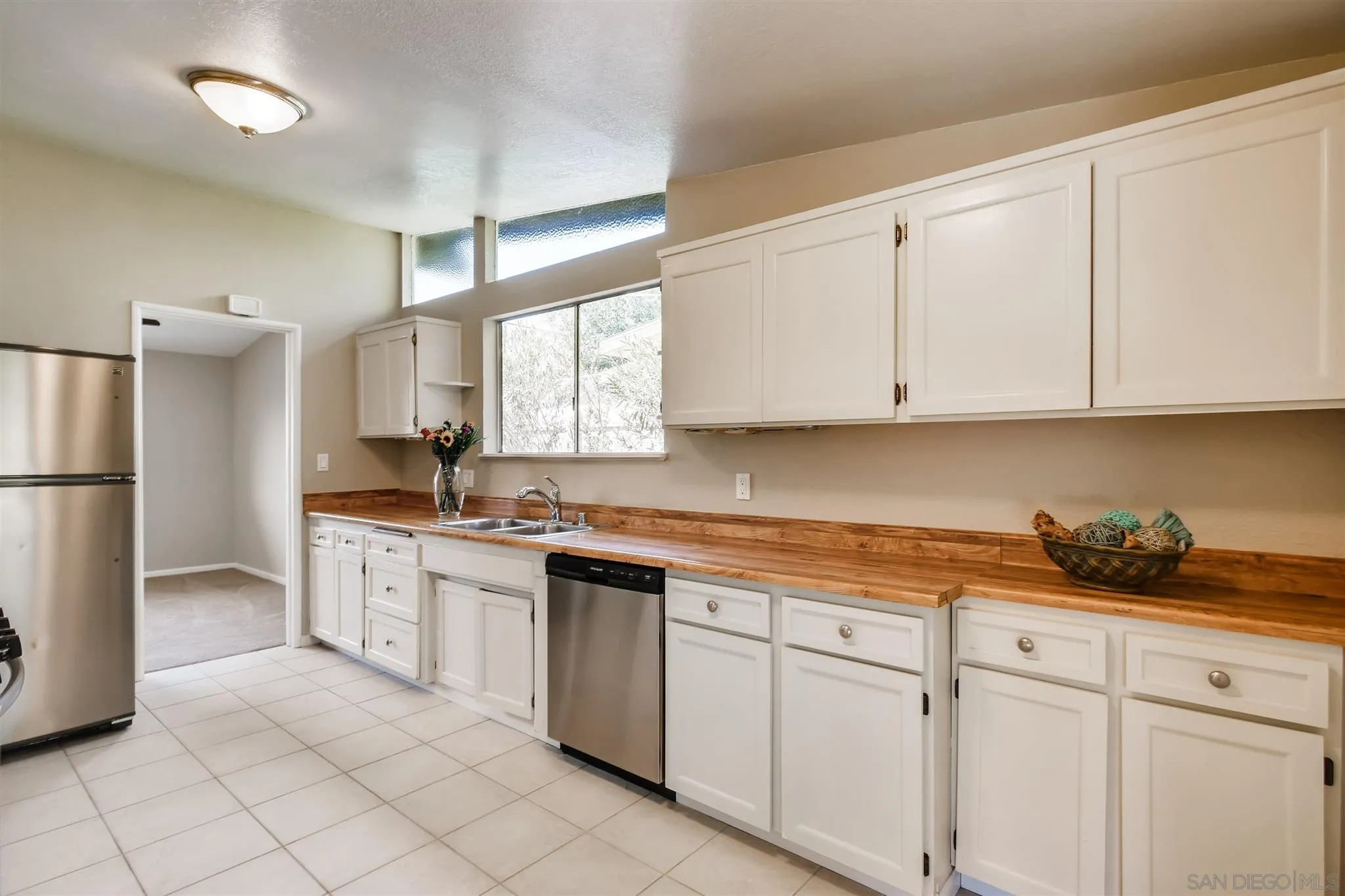 13815 Frame Road Poway, CA 92064 - Photo 5 of 12 a kitchen with white cabinets and white appliances