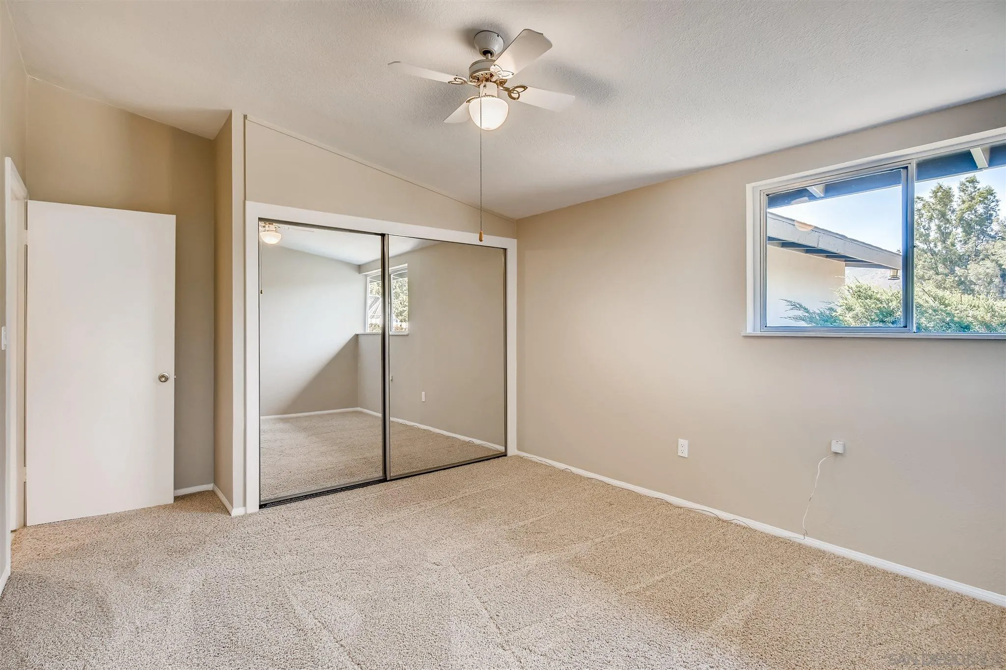13815 Frame Road Poway, CA 92064 - Photo 6 of 12 an empty room with windows and fan