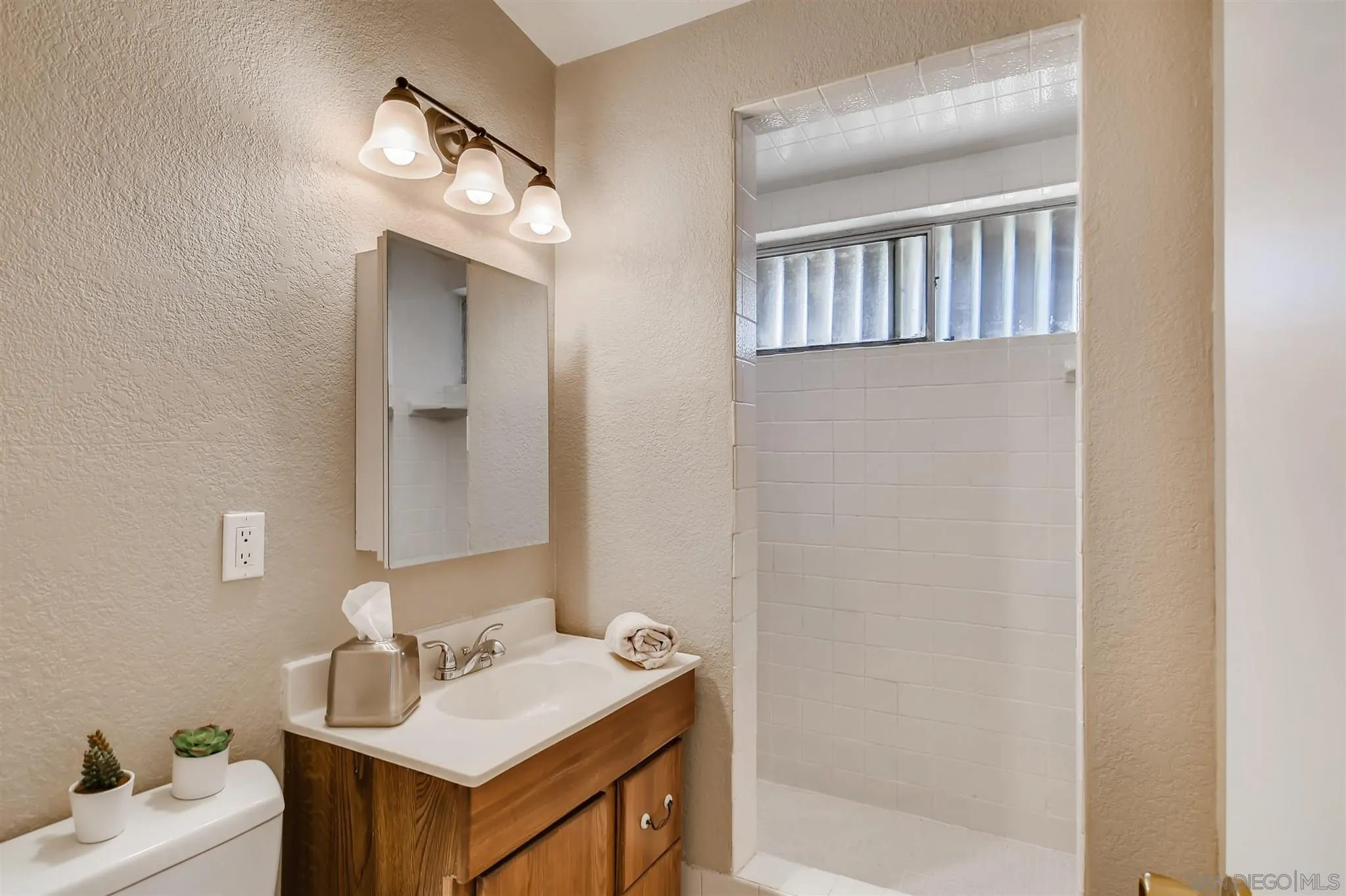 13815 Frame Road Poway, CA 92064 - Photo 7 of 12 a bathroom with a sink vanity and a mirror