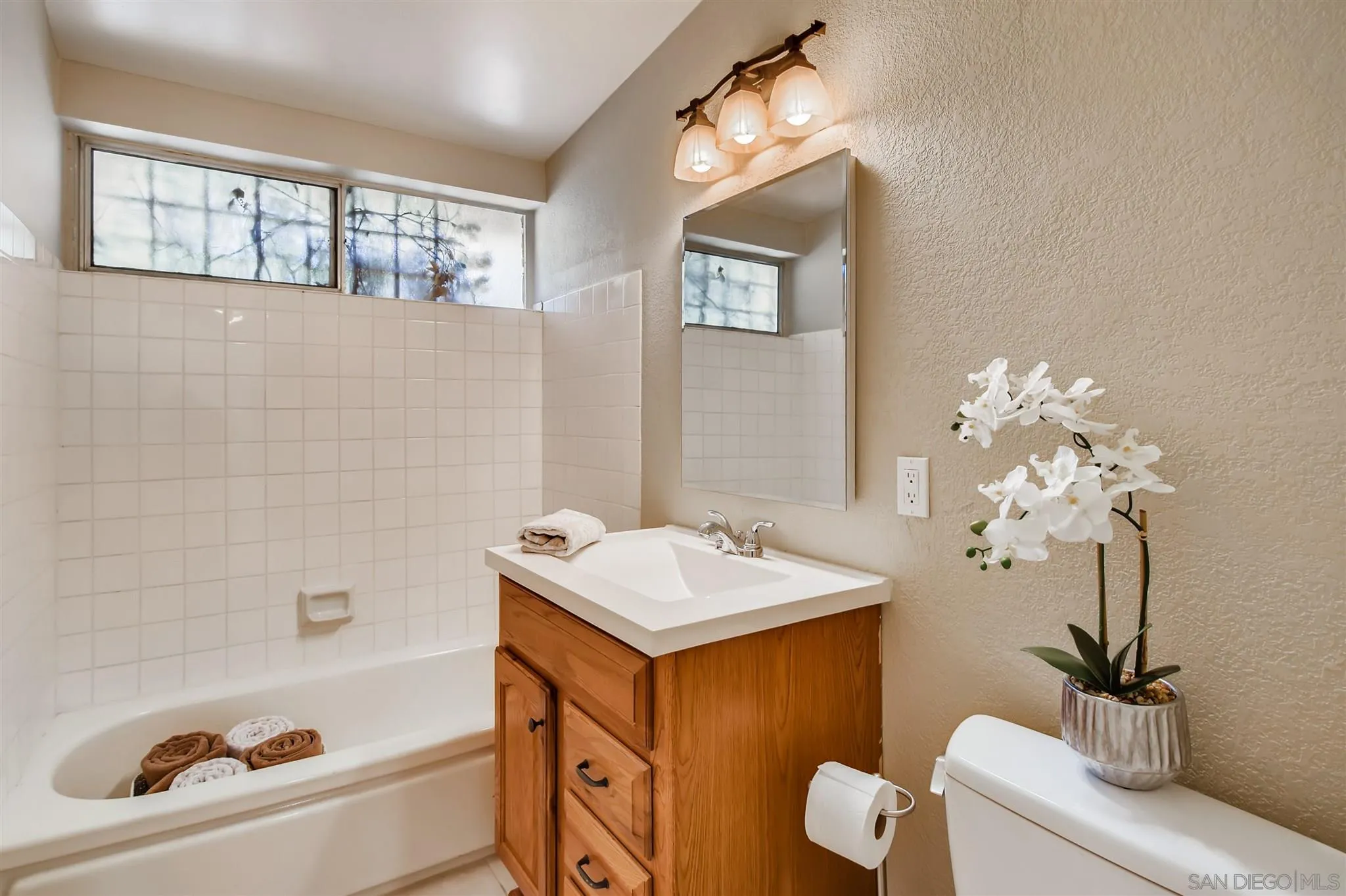 13815 Frame Road Poway, CA 92064 - Photo 9 of 12 a bathroom with a tub sink and mirror