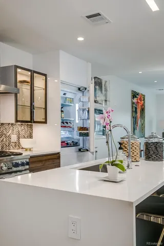 a kitchen with a sink and a refrigerator