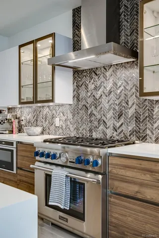 a kitchen with stainless steel appliances a stove and a sink