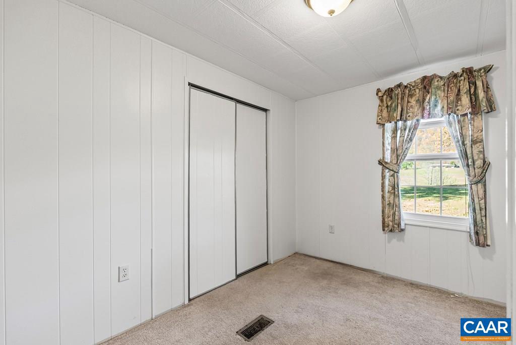 1066 Stevens Cove Road Lovingston, VA 22949 - Photo 20 of 34 an empty room with windows