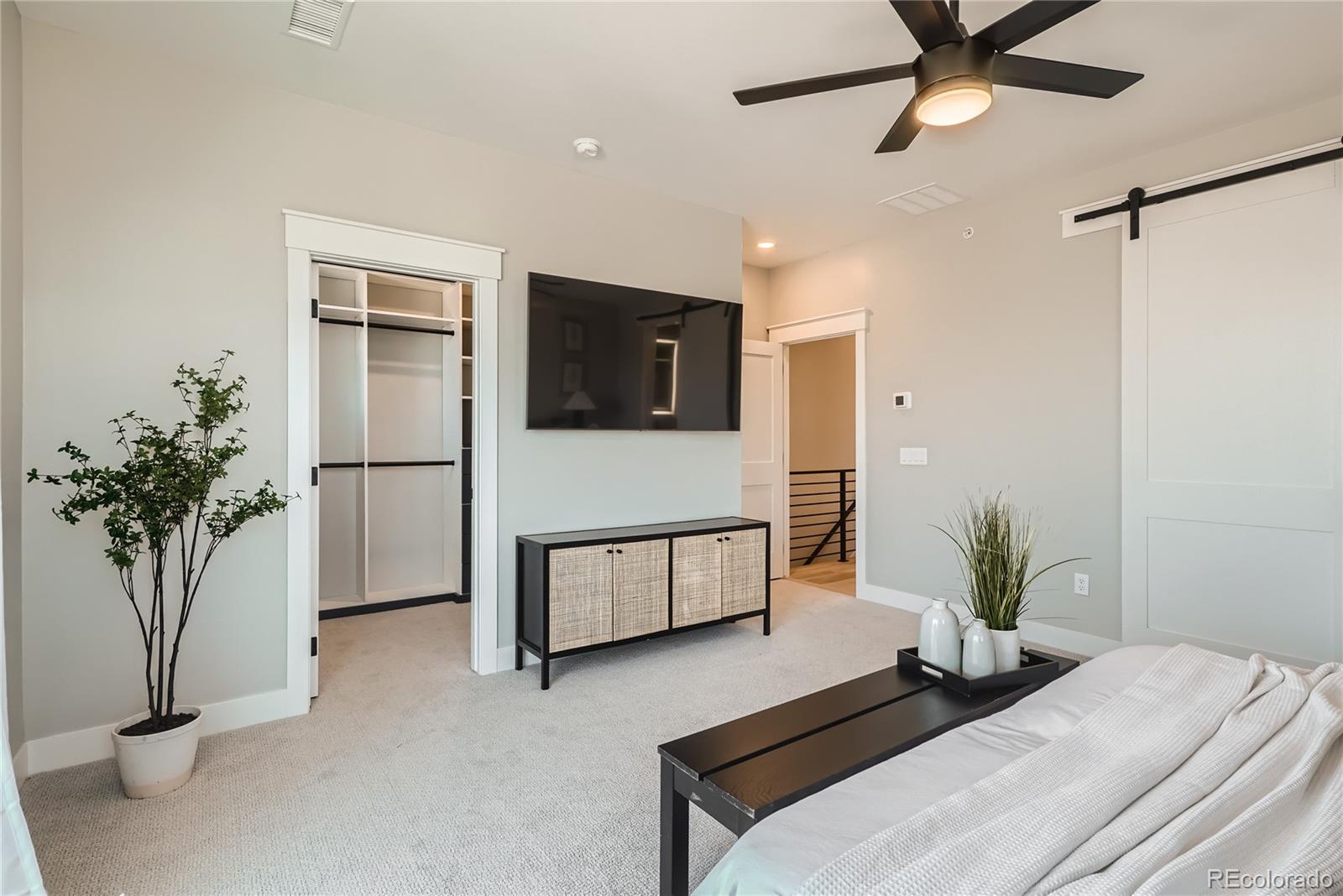 308 East Orchard Road Centennial, CO 80121 - Photo 14 of 26 a bedroom with a bed and a potted plant