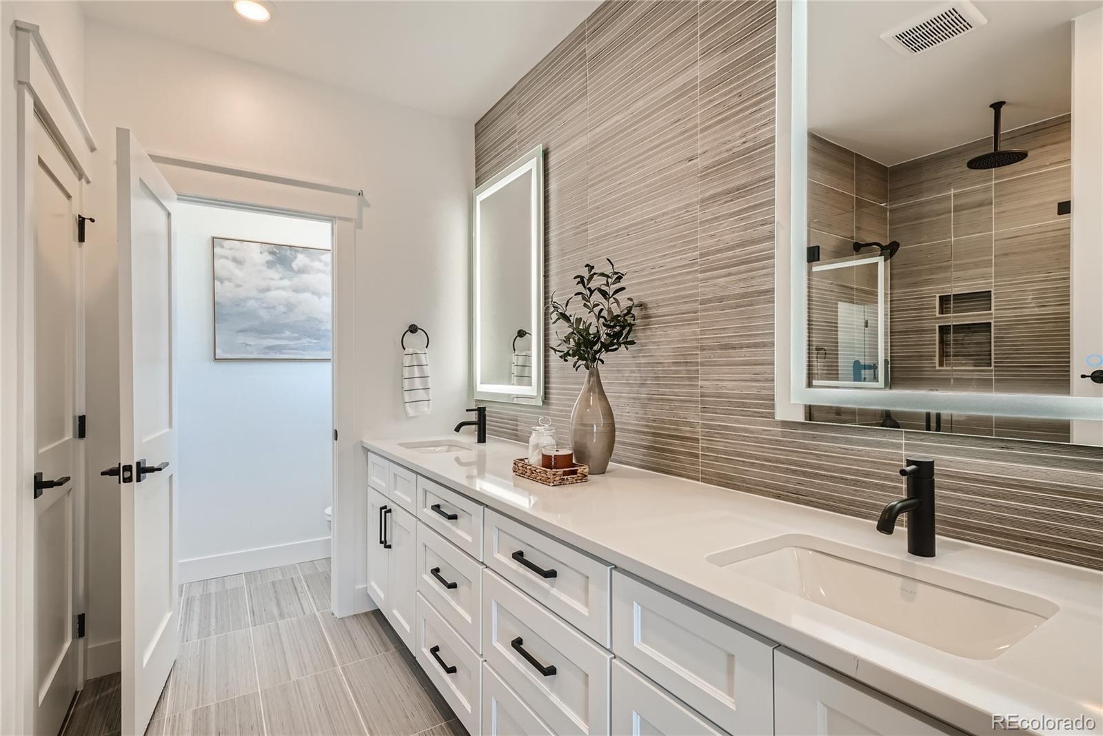308 East Orchard Road Centennial, CO 80121 - Photo 15 of 26 a bathroom with a sink double vanity and a mirror