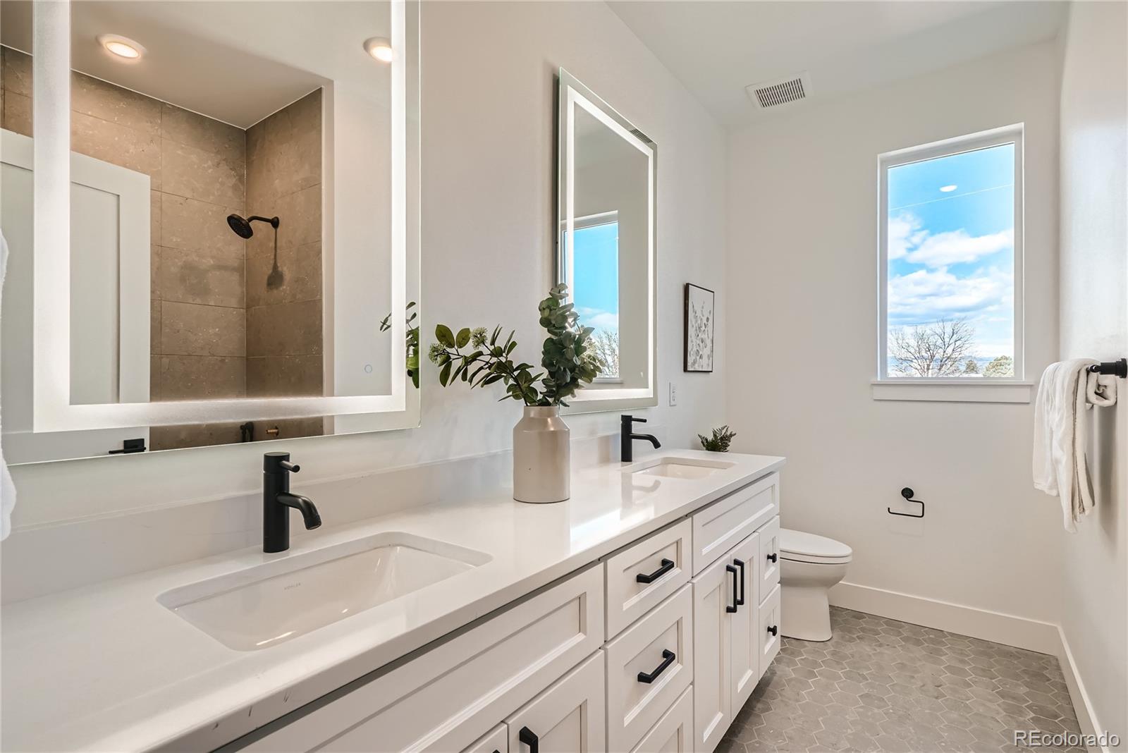 308 East Orchard Road Centennial, CO 80121 - Photo 18 of 26 a bathroom with double sink and a mirror