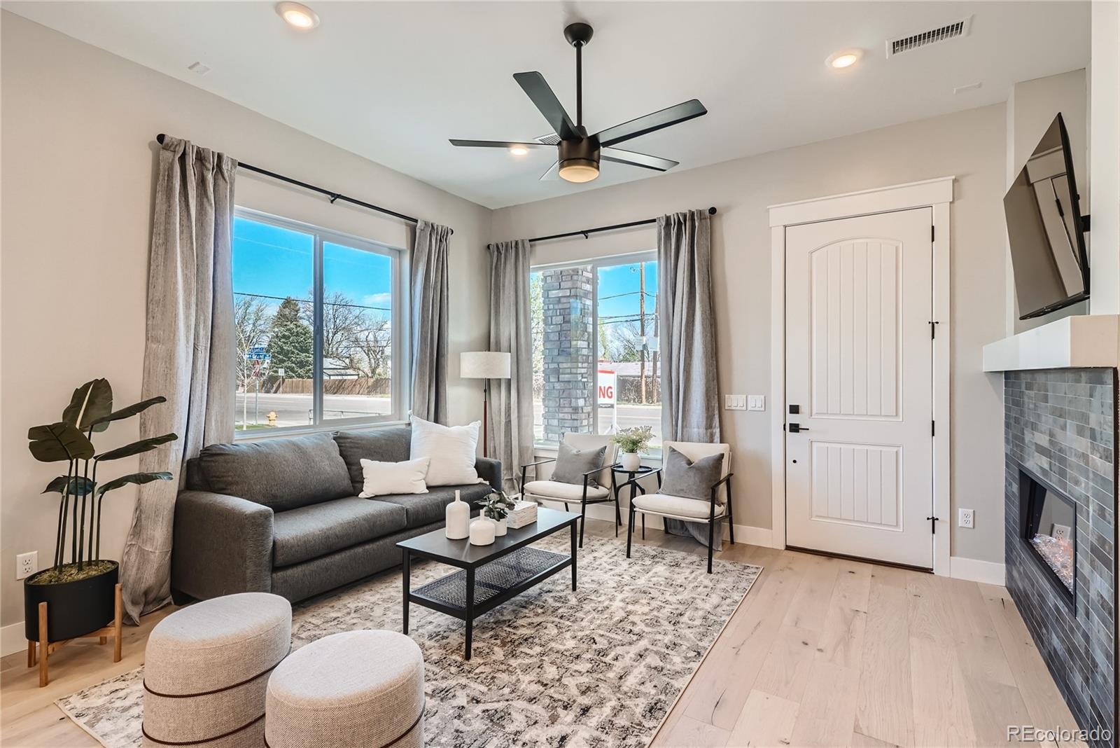 308 East Orchard Road Centennial, CO 80121 - Photo 3 of 26 a living room with furniture a fireplace and a rug