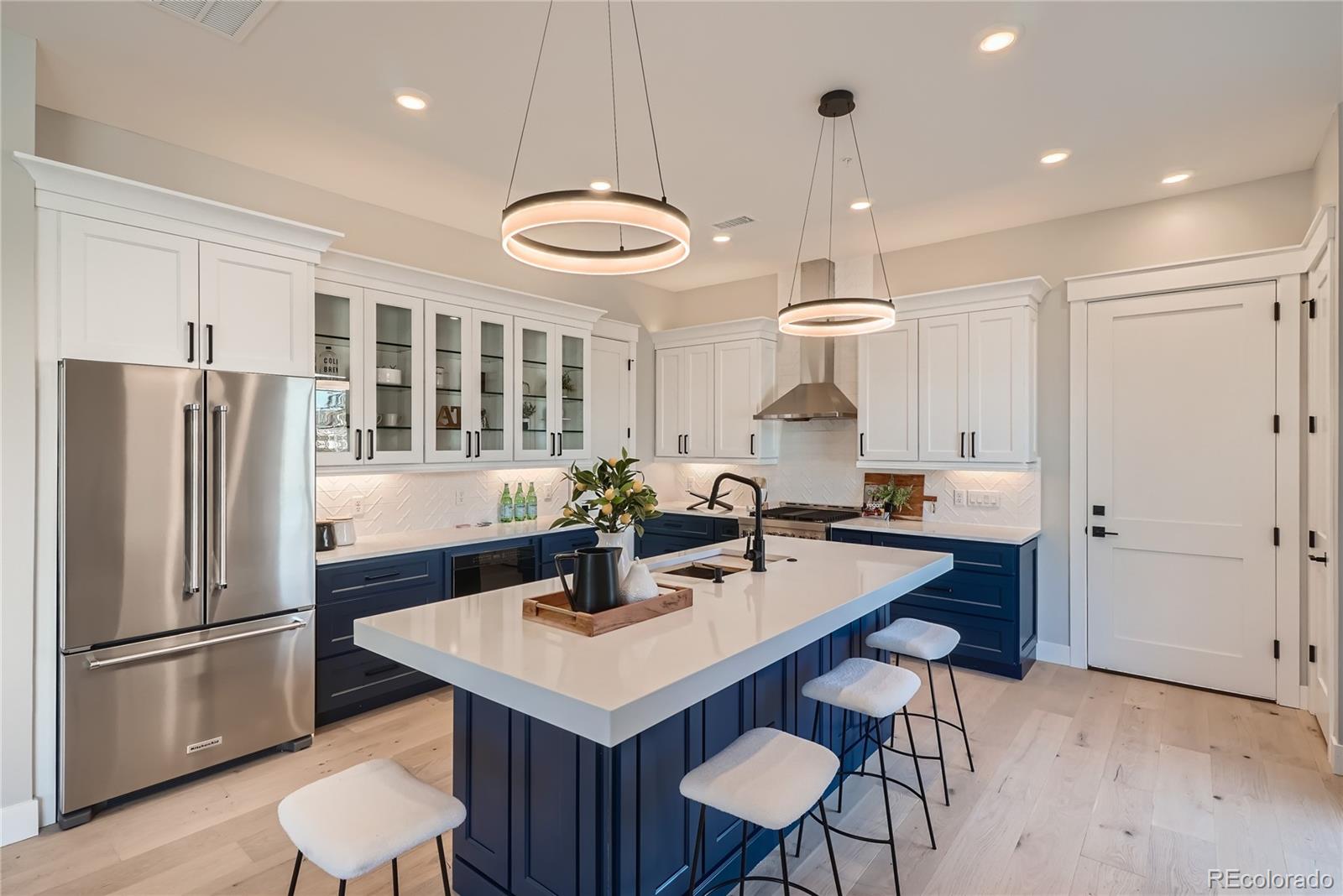308 East Orchard Road Centennial, CO 80121 - Photo 8 of 26 a kitchen with stainless steel appliances a table and chairs