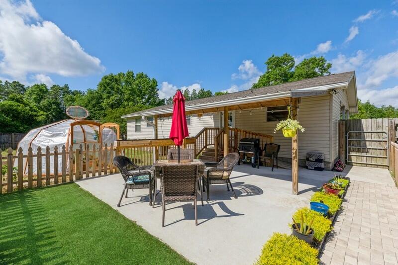 671 Ridge Lake Road Crestview, FL 32536 - Photo 3 of 25 a view of a patio with table and chairs potted plants and a palm tree