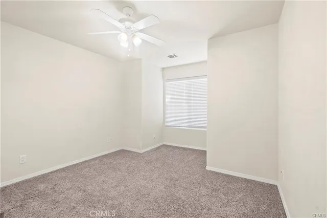 a view of a room with wooden floor and a fireplace