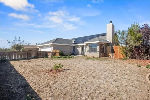 a view of a house with wooden fence