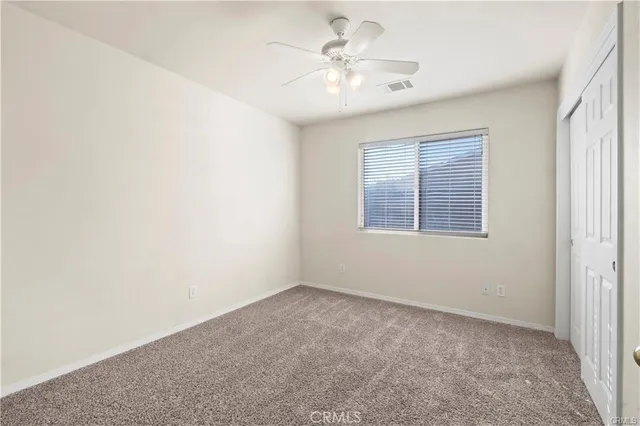 a bathroom with a granite countertop sink a toilet and a mirror