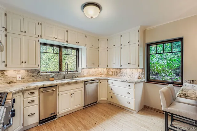 a kitchen with a sink window and cabinets