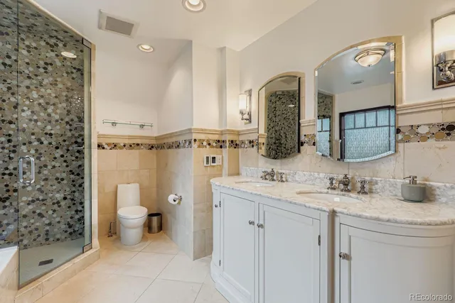a bathroom with a toilet a sink and a mirror