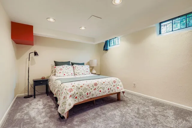 a bedroom with a bed and a lamp