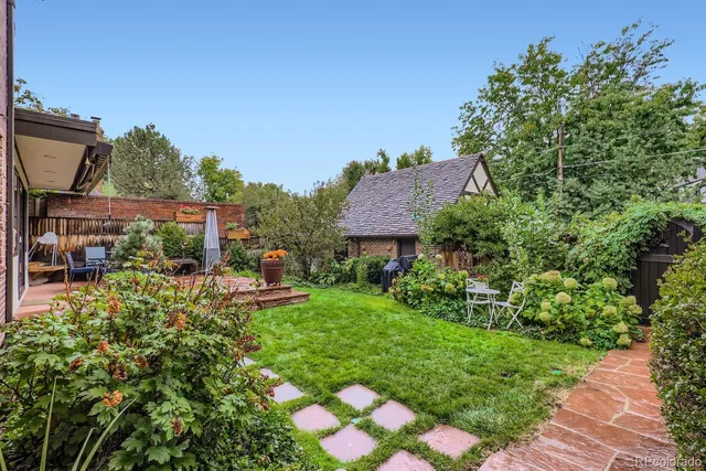 a view of a house with a backyard and a garden