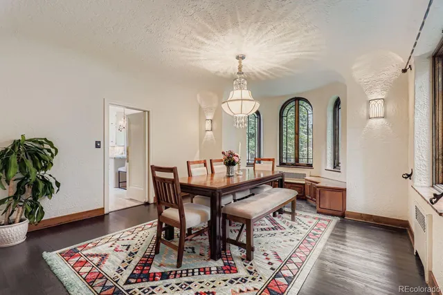 a view of a a dining room with furniture window and wooden floor