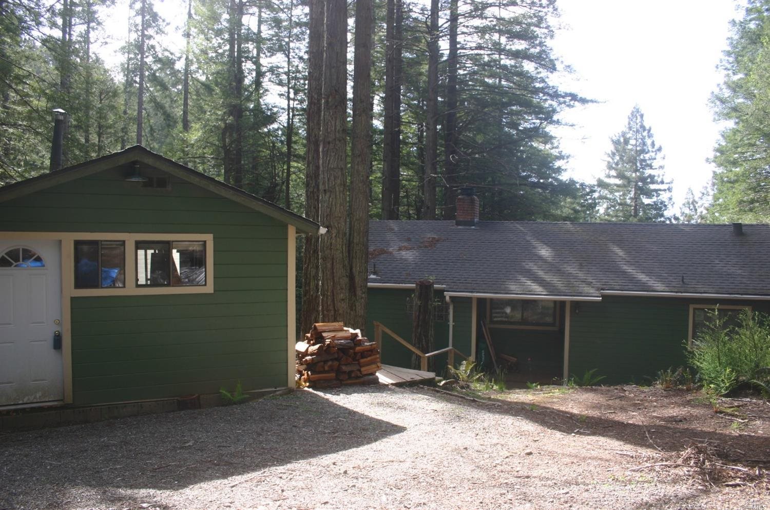 46651 Fish Rock Road Gualala, CA 95445 - Photo 1 of 1 a front view of a house with a yard