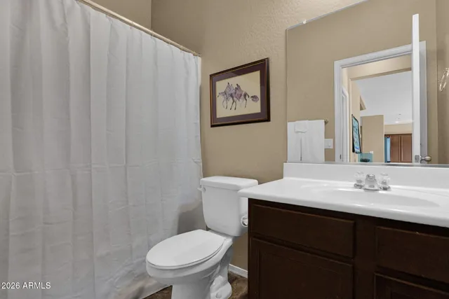 a kitchen with stainless steel appliances granite countertop a stove top oven a sink a dining table and chairs