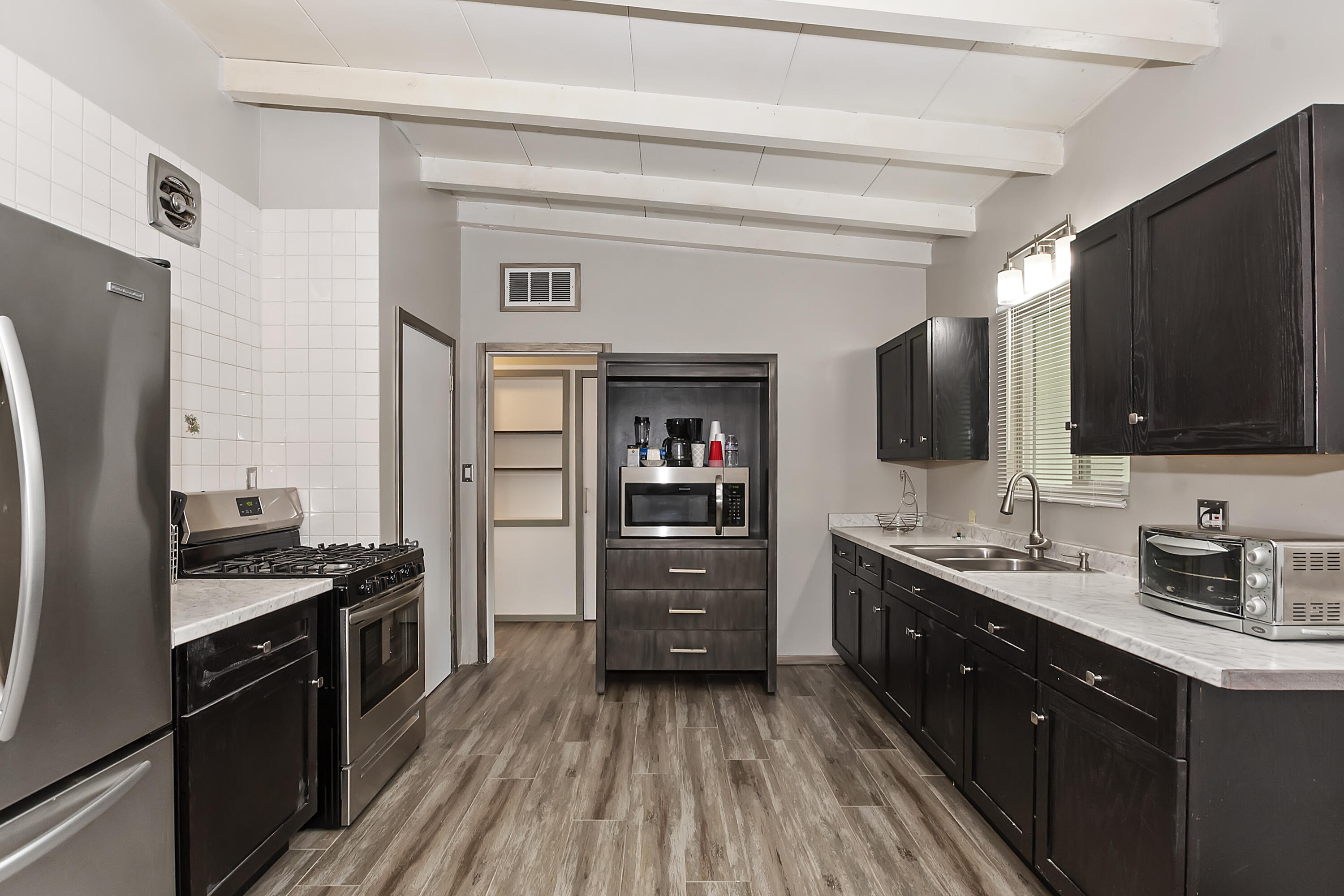 38957 Miller Lane Cathedral City, CA 92234 - Photo 13 of 34 a kitchen with a refrigerator stove and sink