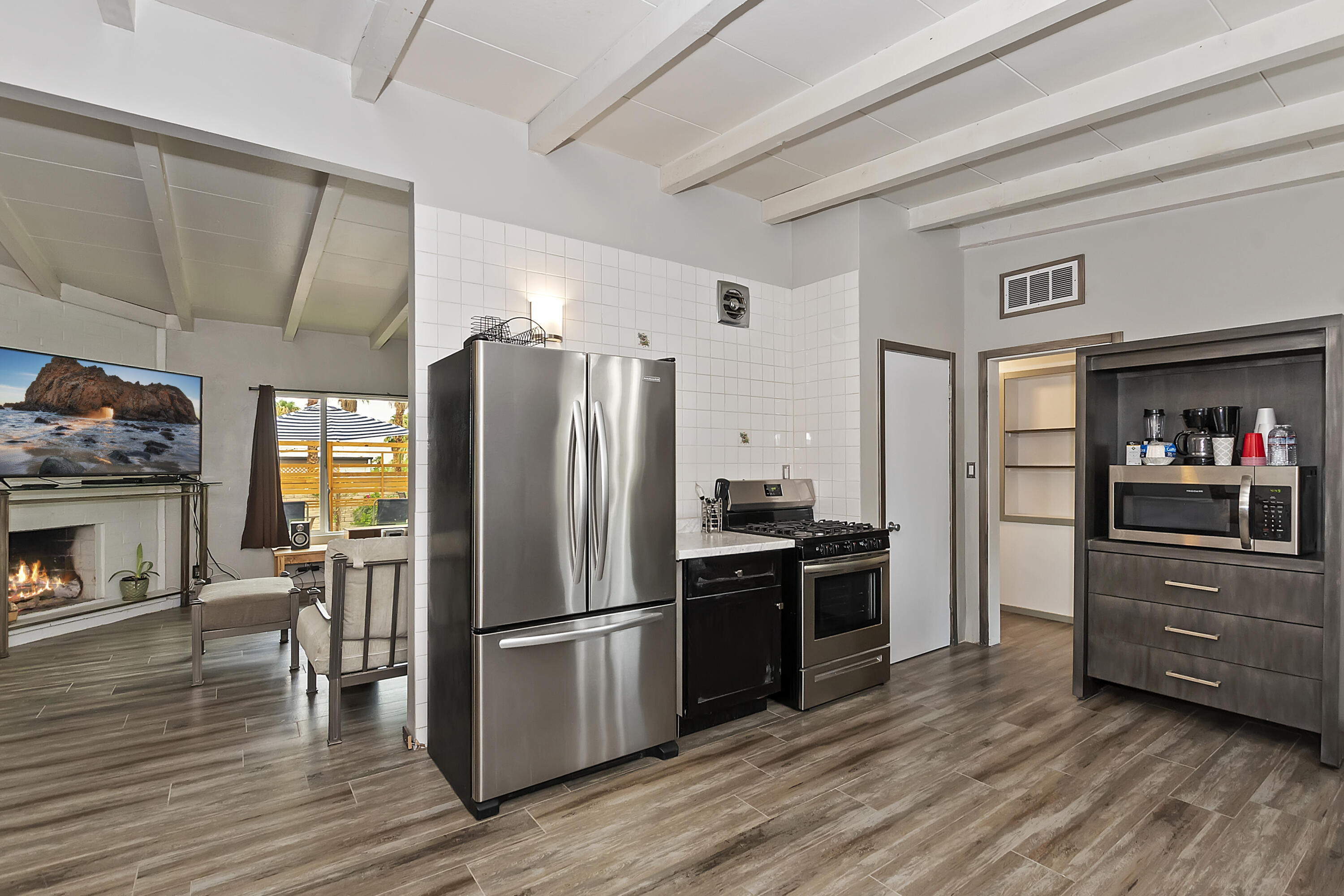 38957 Miller Lane Cathedral City, CA 92234 - Photo 14 of 34 a kitchen with stainless steel appliances a refrigerator and a stove top oven