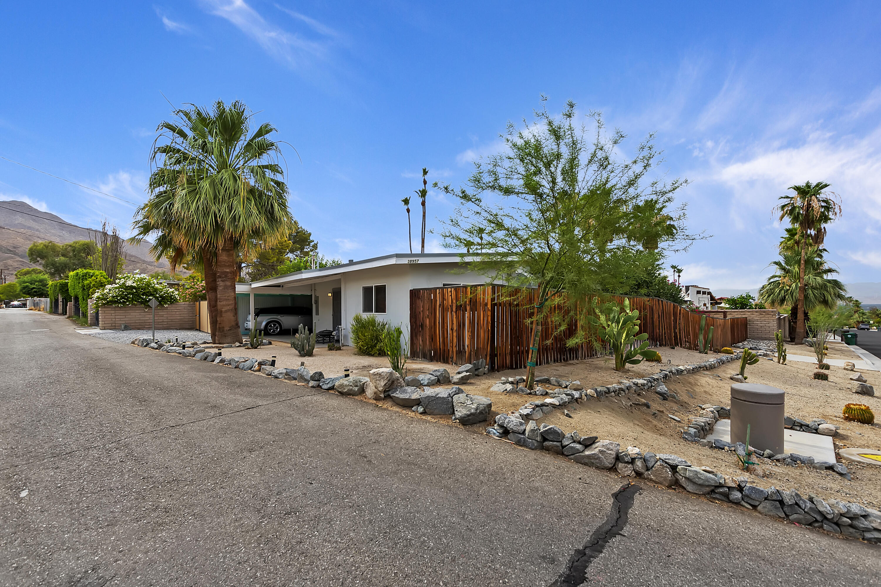 38957 Miller Lane Cathedral City, CA 92234 - Photo 4 of 34 a row of palm trees in front of a house