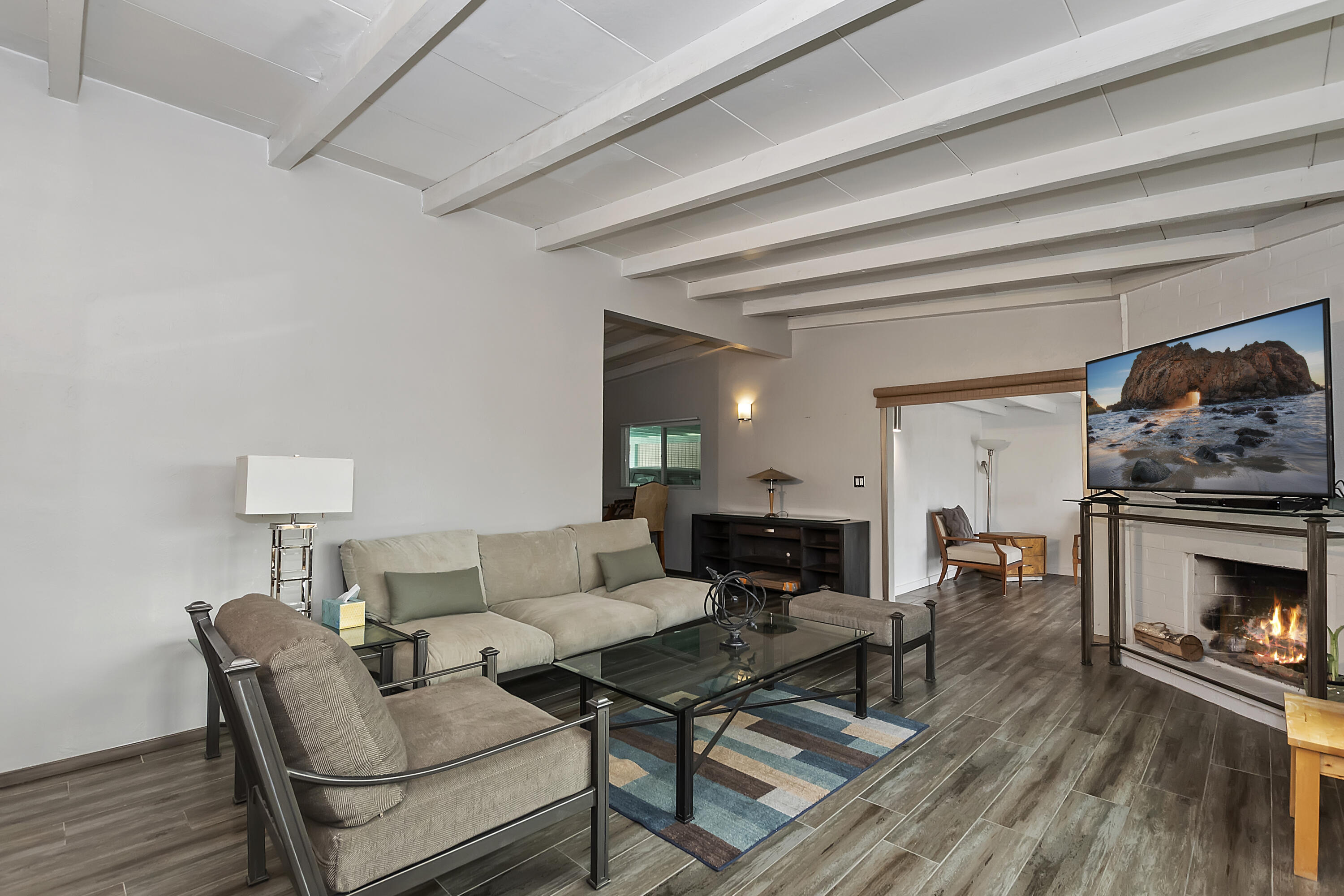 38957 Miller Lane Cathedral City, CA 92234 - Photo 6 of 34 a living room with furniture a fireplace and a wooden floor