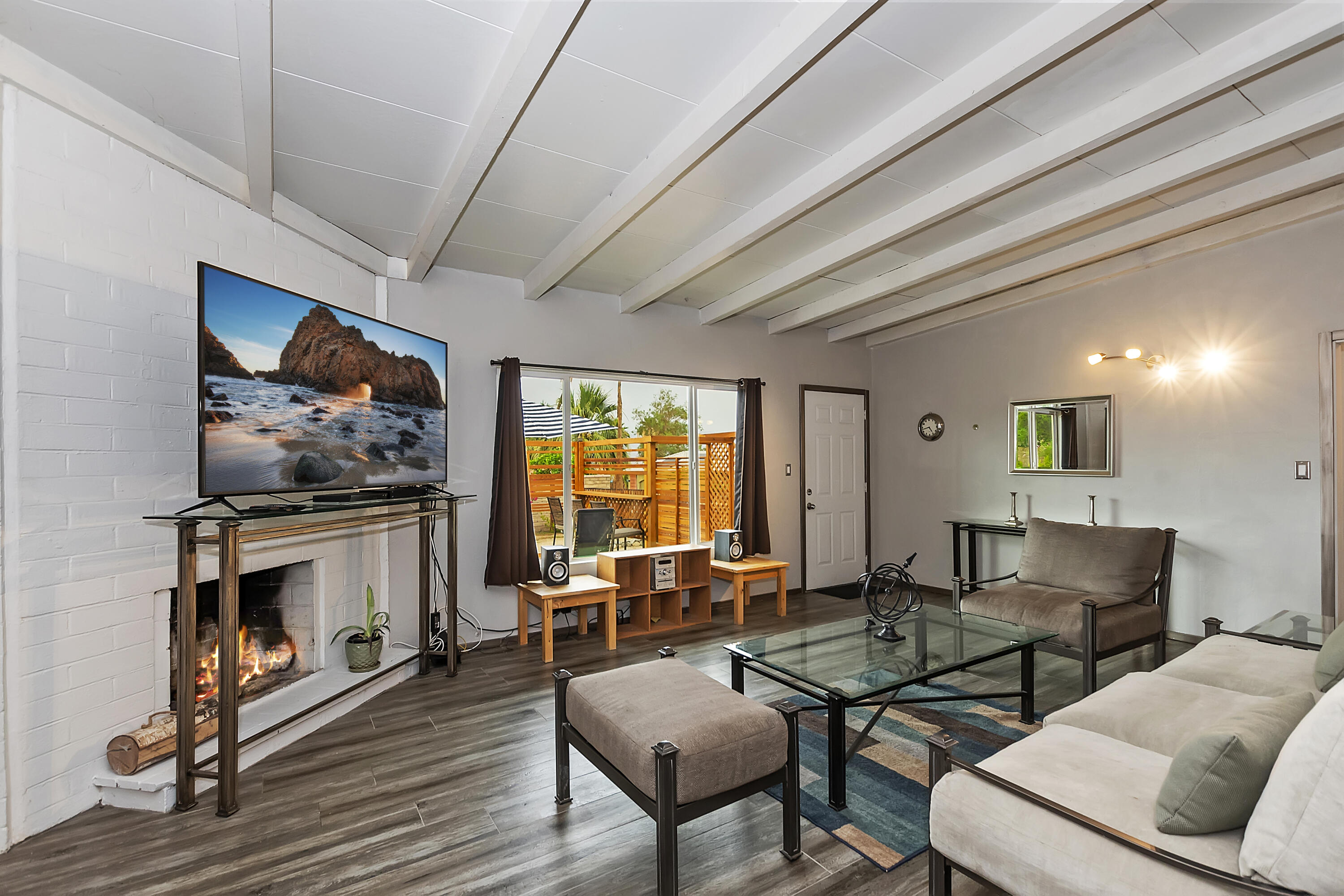 38957 Miller Lane Cathedral City, CA 92234 - Photo 8 of 34 a living room with furniture a flat screen tv and a fireplace