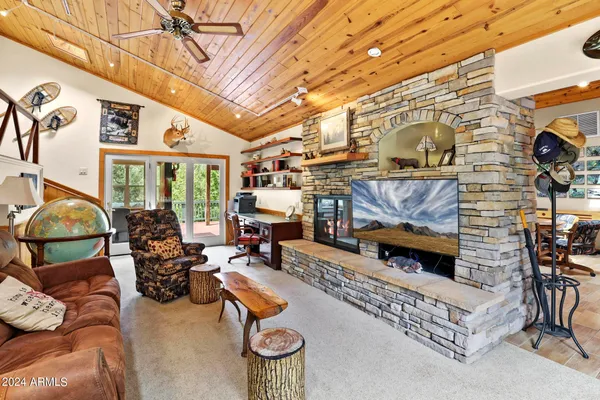 a room with pool table and windows