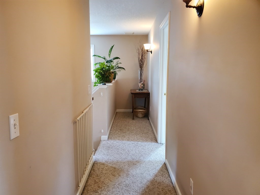 61 Windemere Street Springfield, MA 01104 - Photo 31 of 42 a view of a hallway with wooden floor and a bathroom
