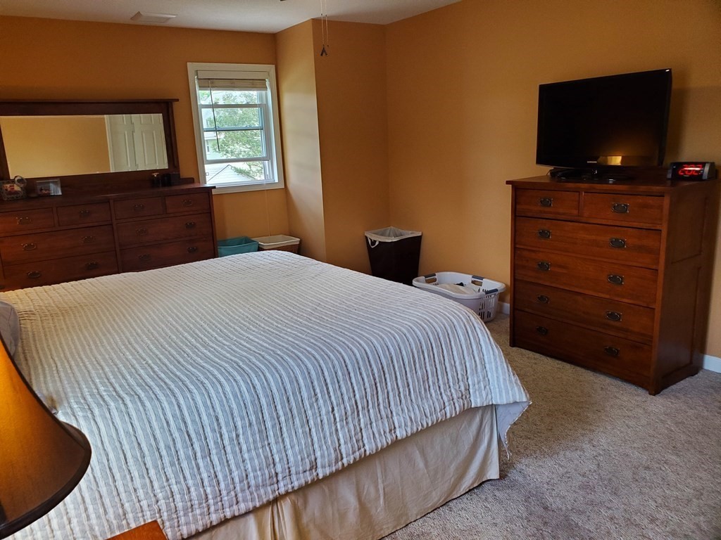 61 Windemere Street Springfield, MA 01104 - Photo 36 of 42 a bedroom with a bed and flat screen tv