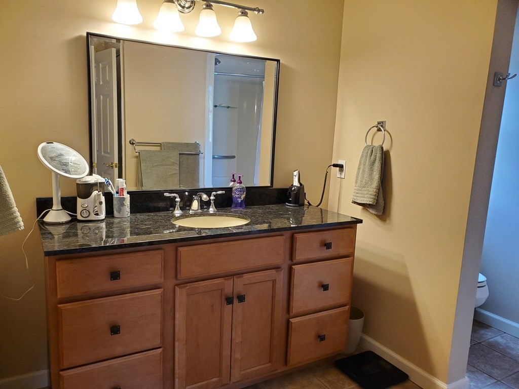 61 Windemere Street Springfield, MA 01104 - Photo 37 of 42 a bathroom with a granite countertop double vanity sink and mirror