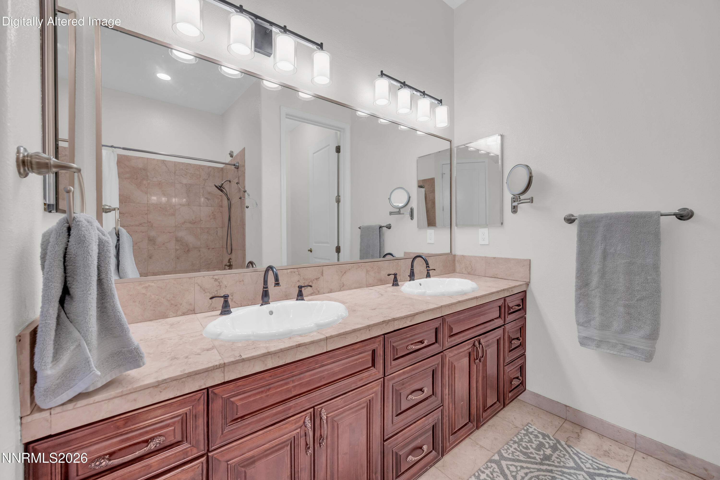 9900 Wilbur May Parkway, Unit 3903 Reno, NV 89521 - Photo 19 of 37 a bathroom with a granite countertop sink a large mirror and shower