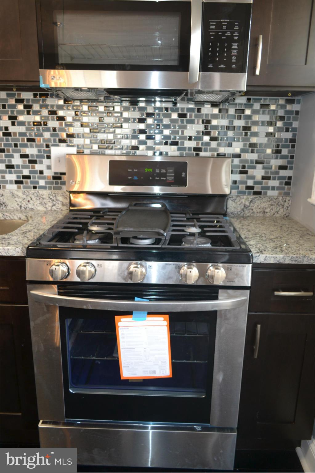 5216 Kelway Road Baltimore, MD 21239 - Photo 3 of 28 a stove top oven sitting inside of a kitchen