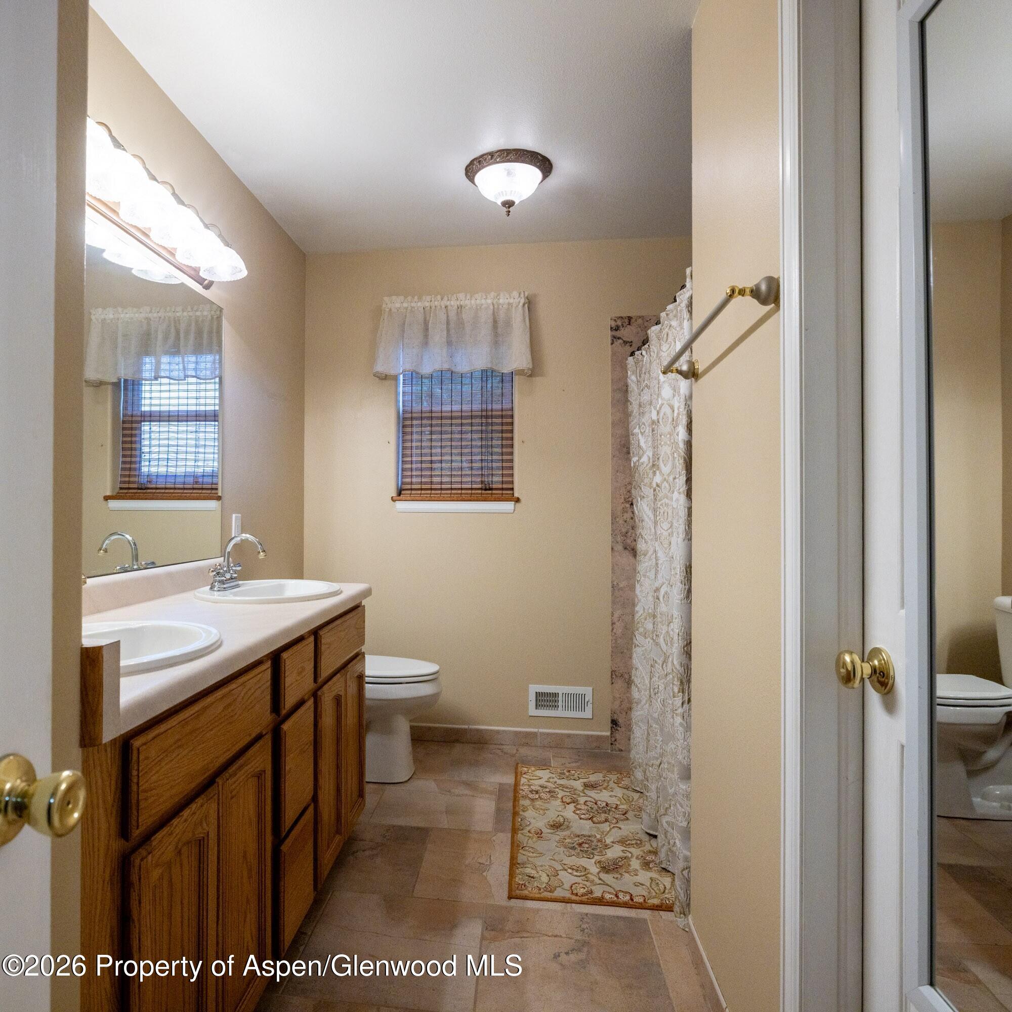 1335 Firethorn Drive Rifle, CO 81650 - Photo 15 of 30 a bathroom with a sink a toilet and shower