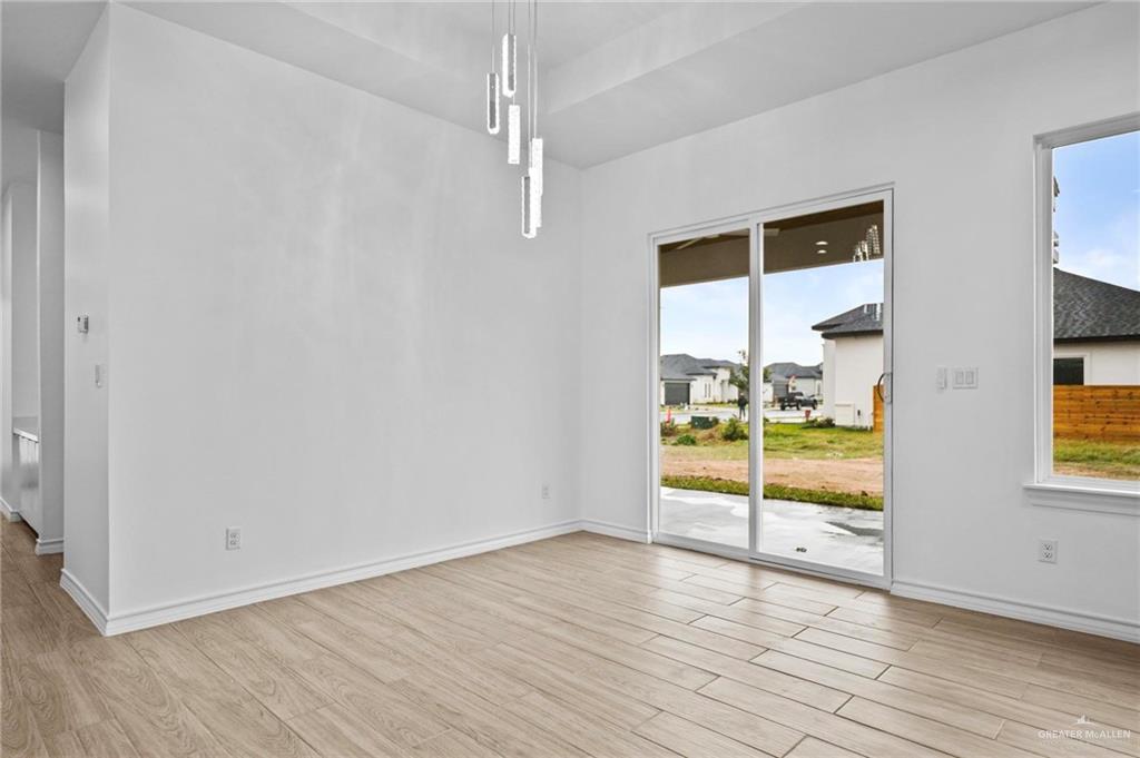 2716 East Conroe Road Edinburg, TX 78542 - Photo 10 of 31 Unfurnished dining area with plenty of natural light and light wood-type flooring
