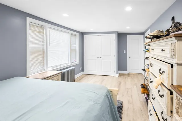 a view of a bedroom with baby crib and toys