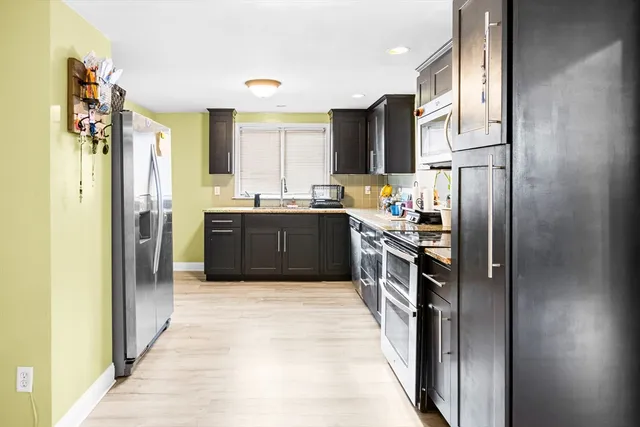 a view of a house with pool and sitting area
