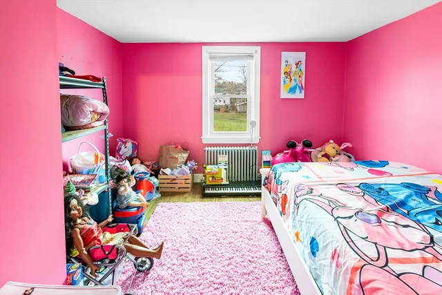 a bed room with a bed and a television