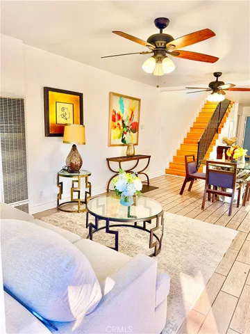 a living room with furniture and next to a window