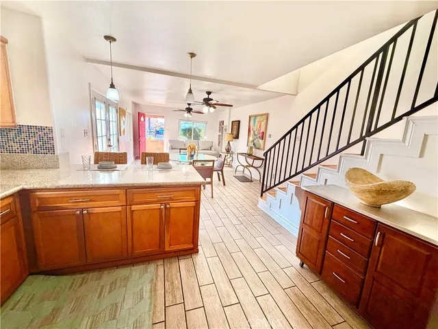 a kitchen with stainless steel appliances granite countertop a sink stove and cabinets