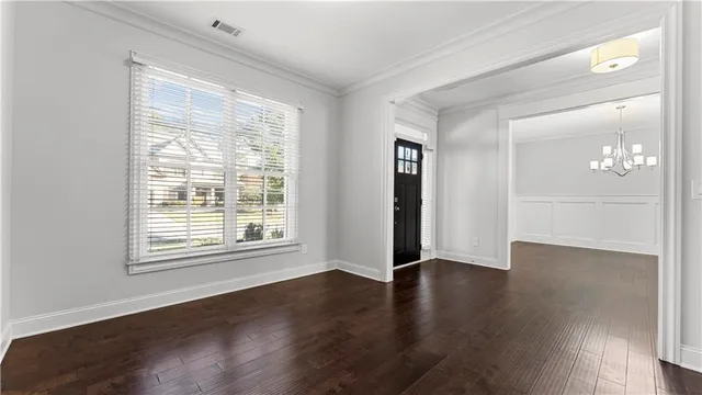 a kitchen with stainless steel appliances granite countertop a stove a refrigerator a kitchen island and chairs