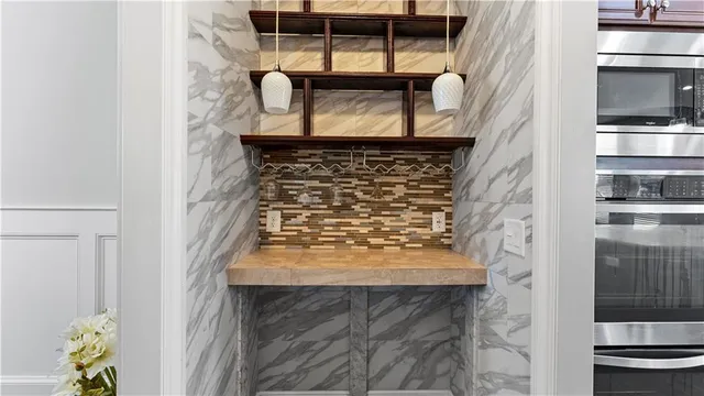 a kitchen with stainless steel appliances granite countertop sink stove refrigerator and cabinets