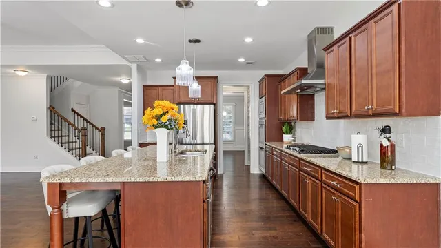 a kitchen with a sink cabinets and wooden floor