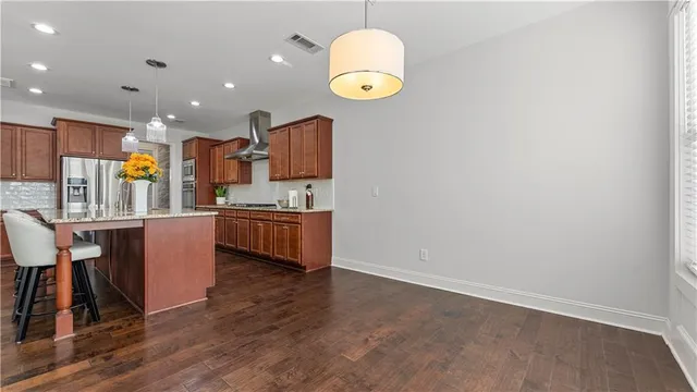 a view of a room with wooden floor and a rug