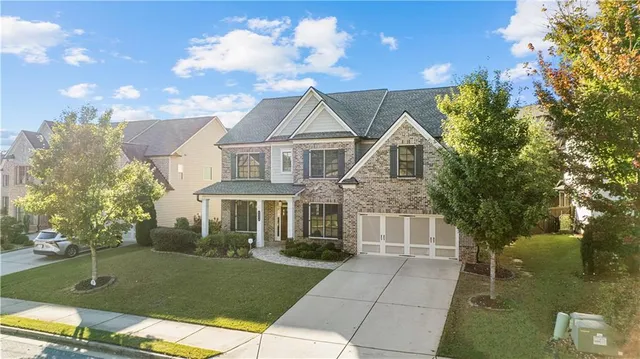 a front view of a house with garden